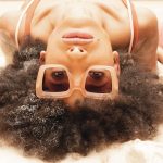 zoomed in women laying down with glasses